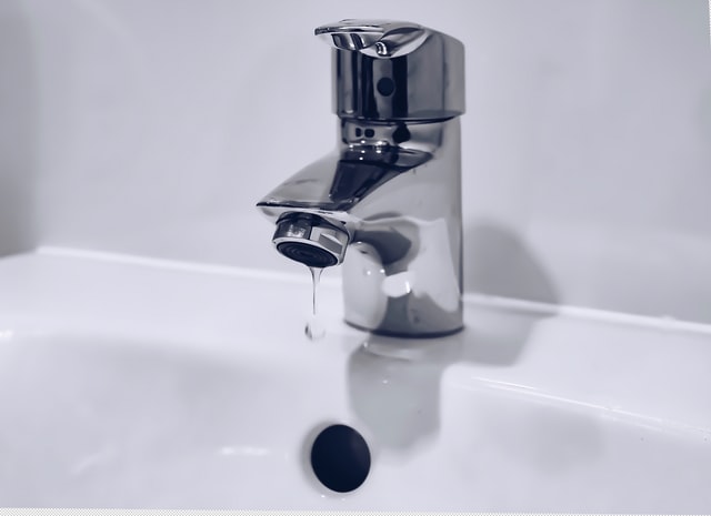 leaky tap symbolising waste