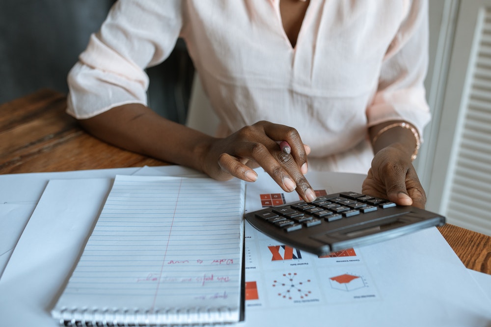 woman calculating tax, for financial planning purposes.